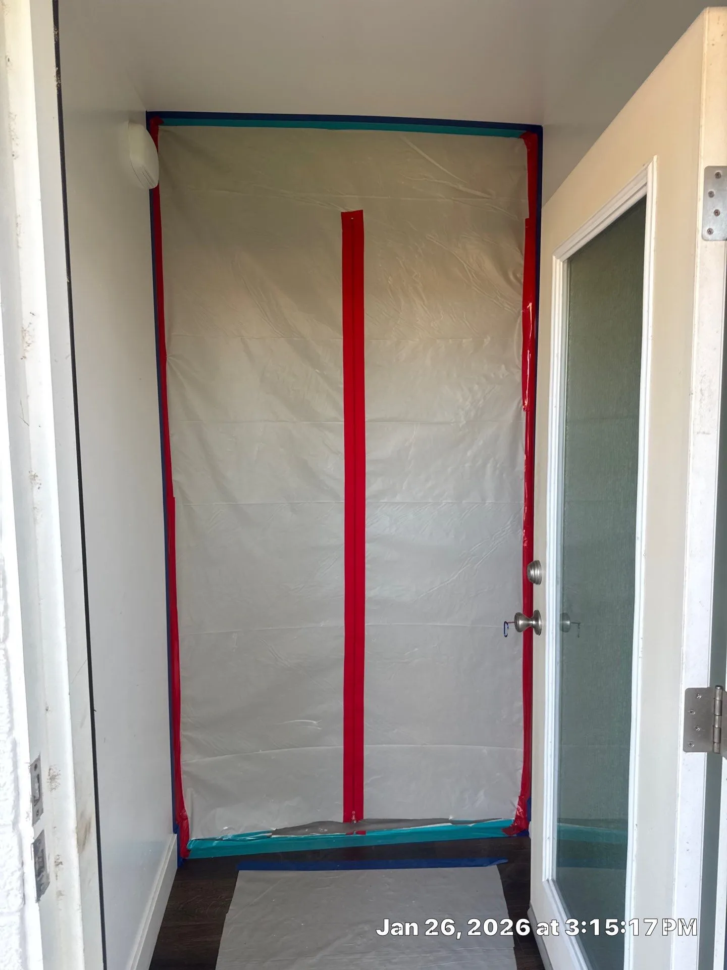 Interior hallway with plastic barrier in red and blue tape.